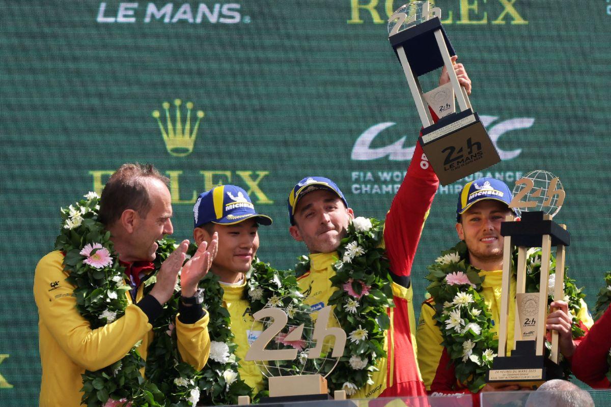 AF Corse's Robert Kubica, Yifei Ye and Philip Hanson celebrate with  along with team principal Amato Ferrari on the podium after winning the 24 Hours of Le Mans at Circuit de la Sarthe, Le Mans, France, on Sunday