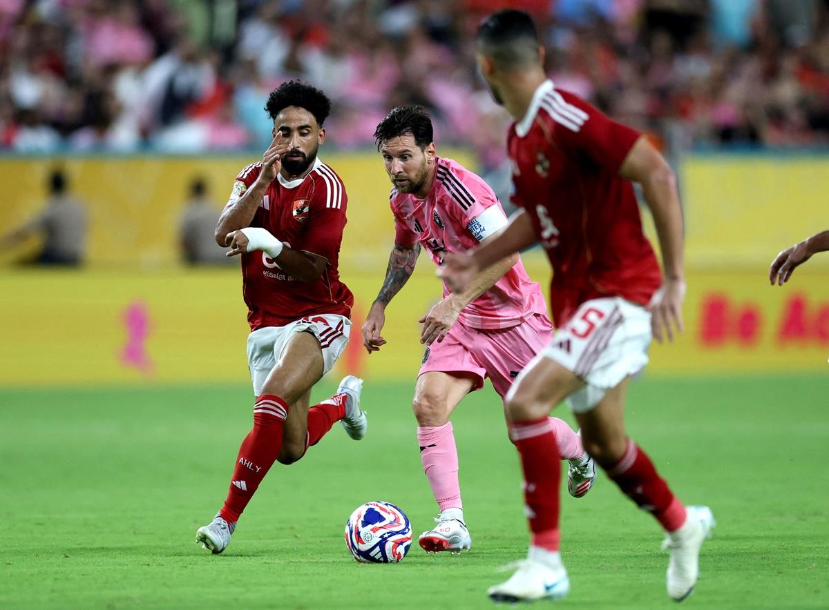 Lionel Messi tries to work his way past Al Ahly defenders.
