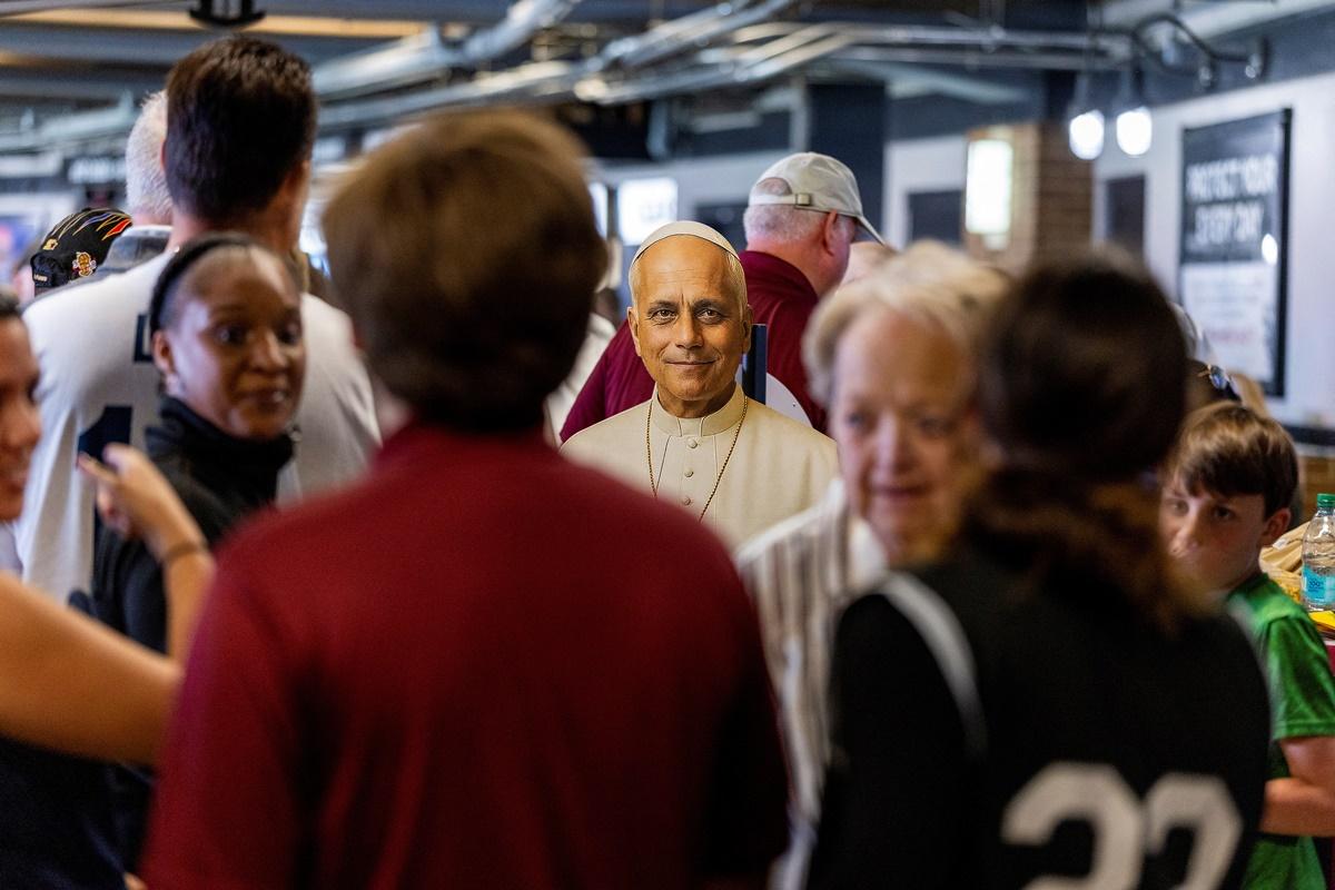 People take photos with a Pope Leo XIV cut out during the public celebration hosted by the Chicago White Sox and Archdiocese of Chicago for the election of Pope Leo XIV, on Saturday.
