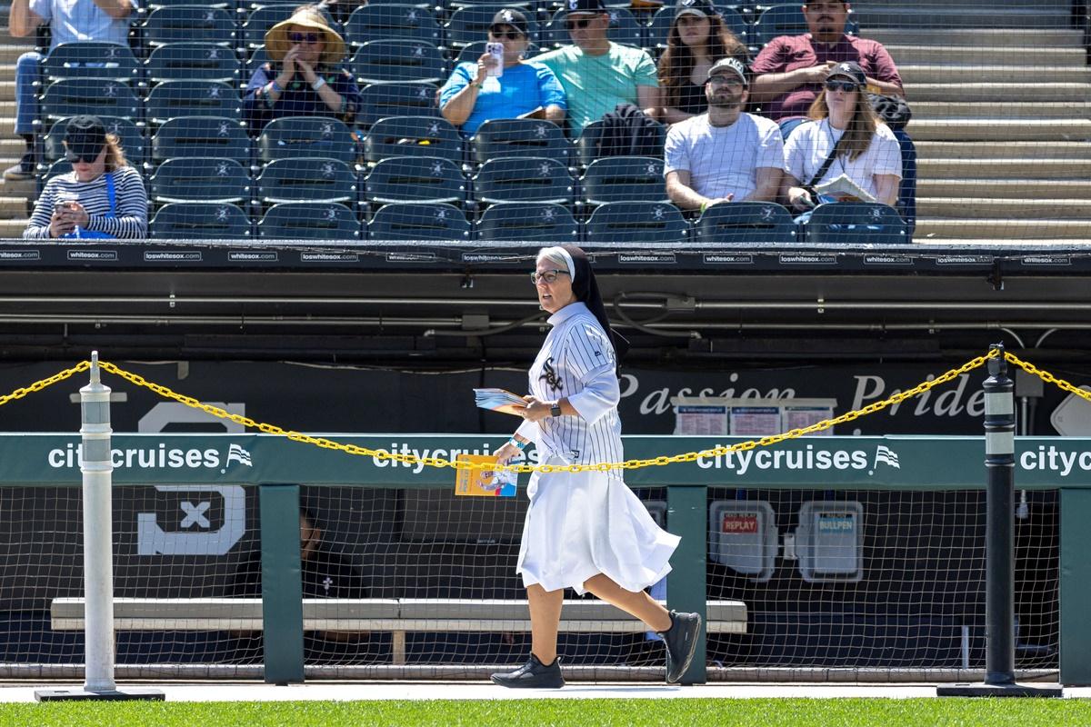 A nun walks on the field wearing a White Sox Jersey during the public celebration. 