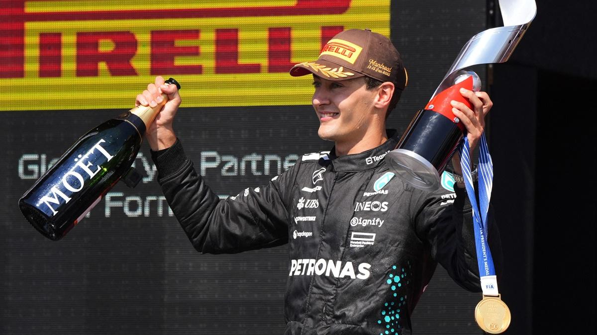 Mercedes's George Russell celebrates with the trophy on the podium after winning the Formula One Canadian Grand Prix at Circuit Gilles Villeneuve, Montreal, Quebec, on Sunday.