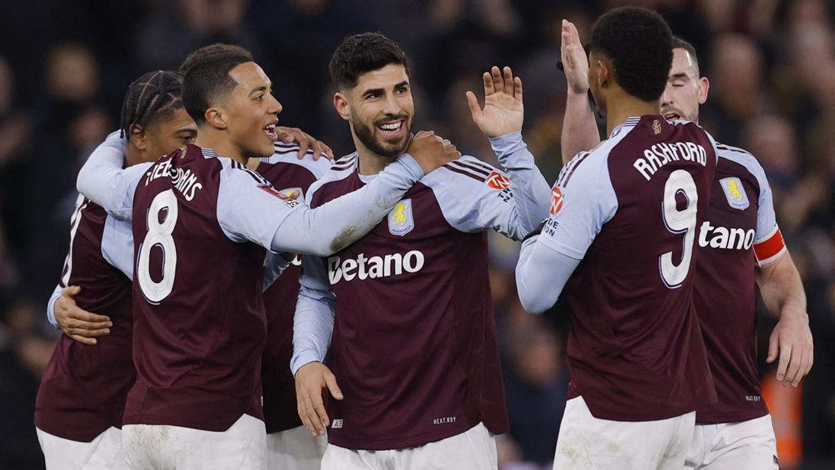 Marco Asensio is congratulated by his Aston Villa teammates after scoring their second goal.