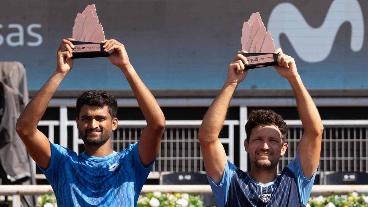 India's Rithvik Choudary Bollipalli and Colombia's Nicolas Barrientos celebrate with their trophies after the Chile Open final in Santiago on Saturday.