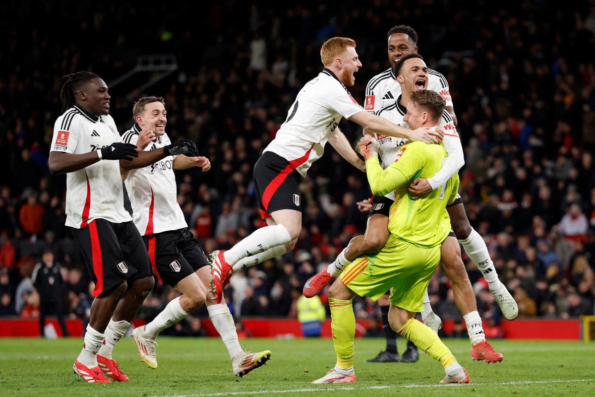 Fulham's Bernd Leno celebrates with his teammates after he saves the penalty and wins them the FA Cup fifth round match against Manchester United, Manchester, on Sunday March 2