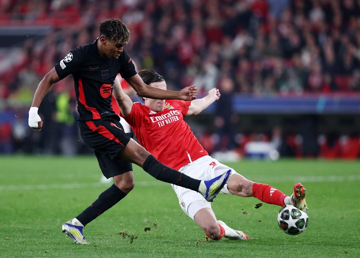 Lamine Yamal is challenged by Benfica's Alvaro Fernandez Carreras as he tries to break through.