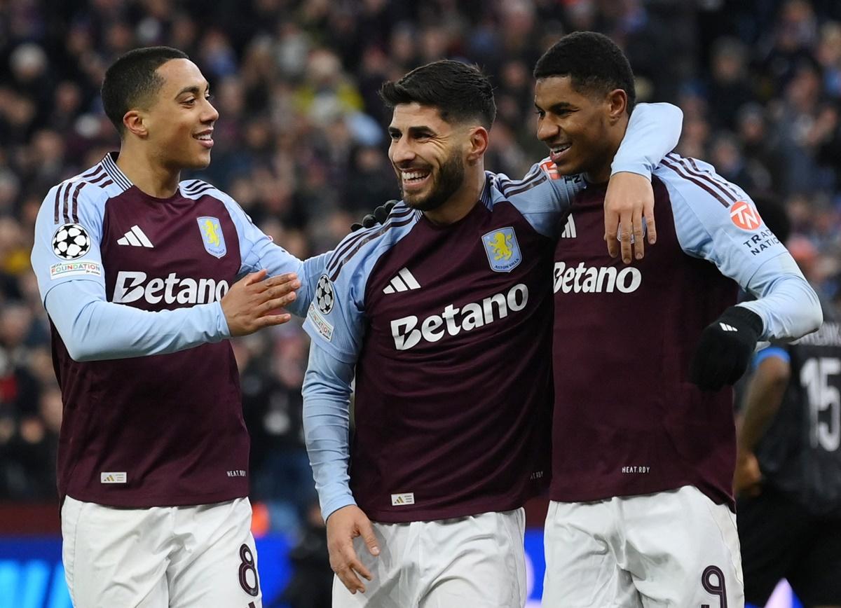 Marco Asensio celebrates with Marcus Rashford and Youri Tielemans after scoring Aston Villa's second goal.