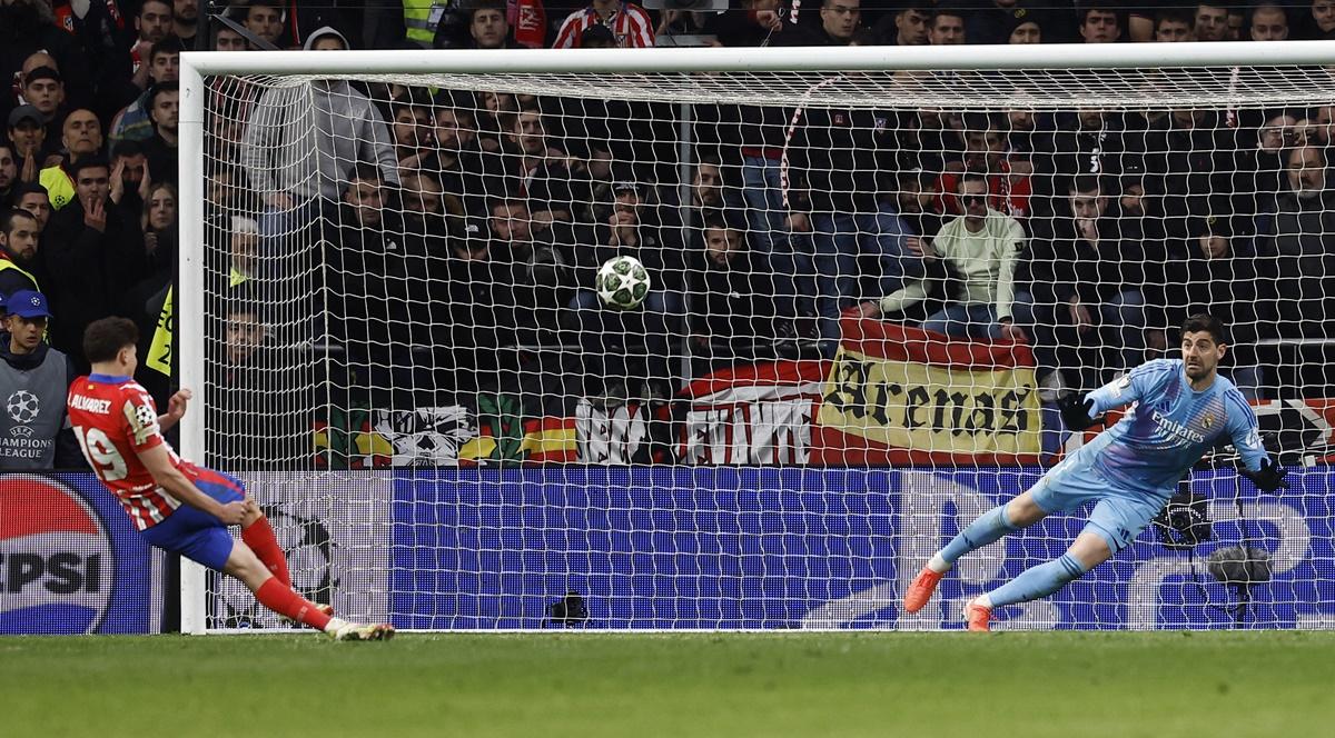 Atletico Madrid's Julian Alvarez slips but sends the ball past Real Madrid goalkeeper Thibaut Courtois during the Champions League Round of 16 second leg penalty shoot-out. The goal was later disallowed after a VAR review.