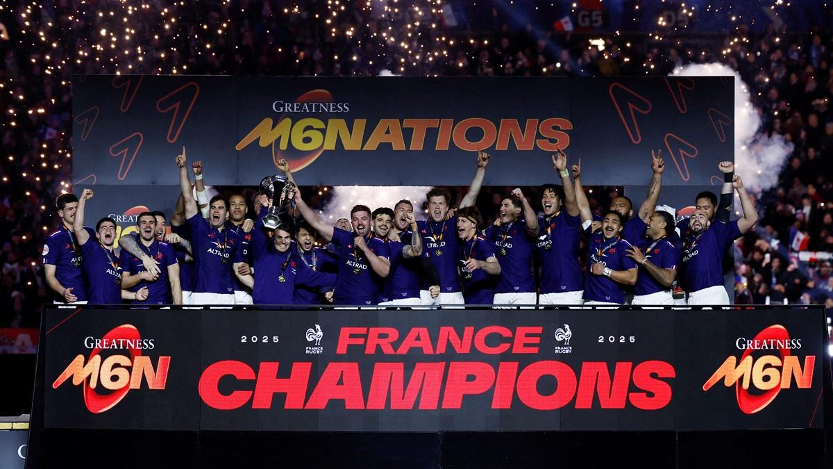 France's Antoine Dupont and Gregory Alldritt lift the Six Nations Rugby trophy as they celebrate on the podium with teammates after beating Scotland at Stade de France, Saint-Denis, on Saturday.