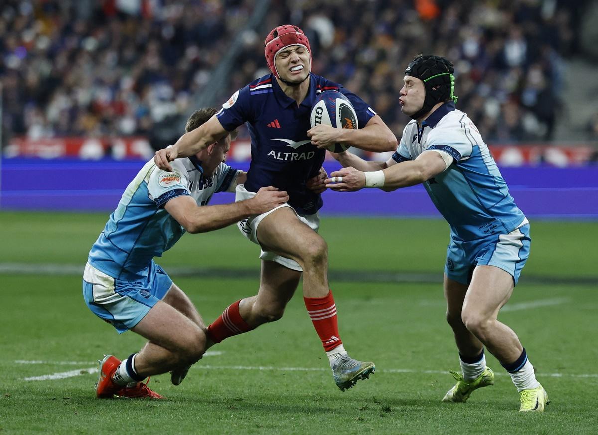 France's Louis Bielle-Biarrey in action with Scotland's Darcy Graham and Huw Jones.