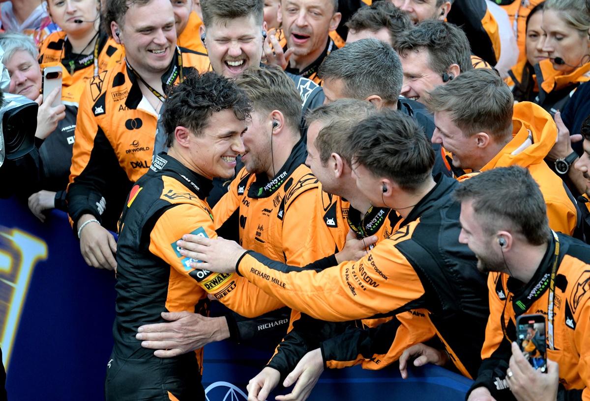 Lando Norris celebrates with teammates after ending defending champion Max Verstappen's long run at the top of the championship standings, dating back to May 2022.