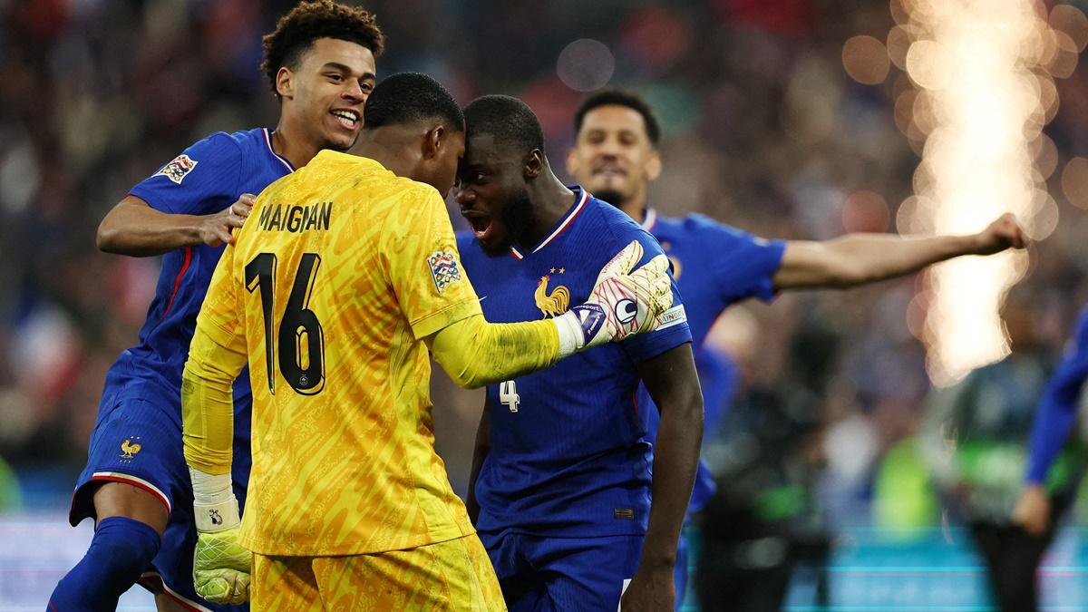 Dayot Upamecano celebrates with Mike Maignan after scoring the winning penalty for France's in the shoot-out against Croatia at Stade de France.