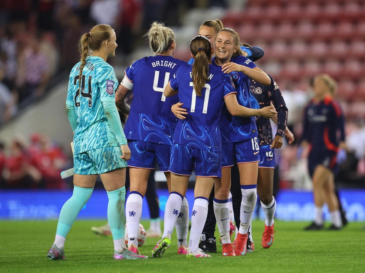 Chelsea's Wieke Kaptein and Guro Reiten celebrate with teammates after the match.