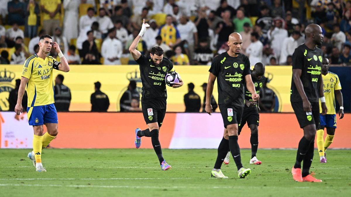 Cristiano Ronaldo wears a dejected looks as Karim Benzema celebrates with the ball after scoring Al Ittihad's first goal in the Saudi Pro League match against Al Nassr at Al-Awwal Park, Riyadh, on Wednesday.