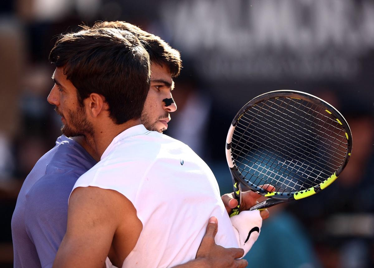 Carlos Alcaraz and Lorenzo Musetti embrace after the final.