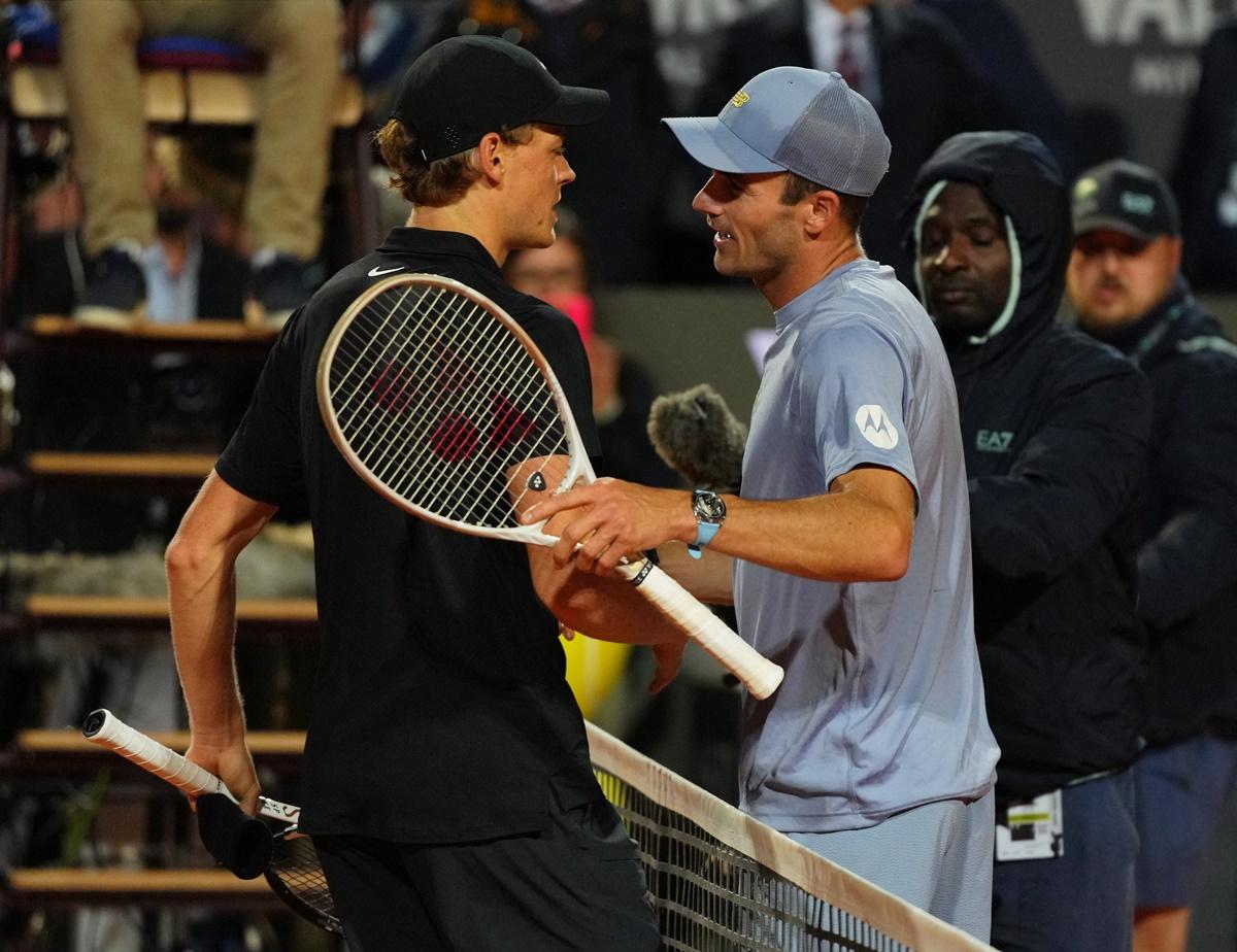 Jannik Sinner and Tommy Paul meet at the net after their semi-final.