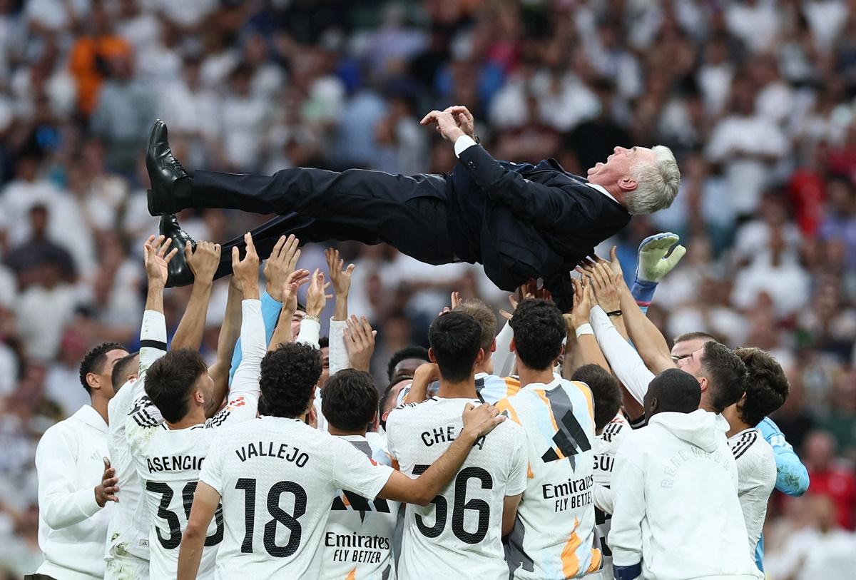 Carlo Ancelotti is thrown in the air in celebration by his players after his last match as Real Madrid coach.