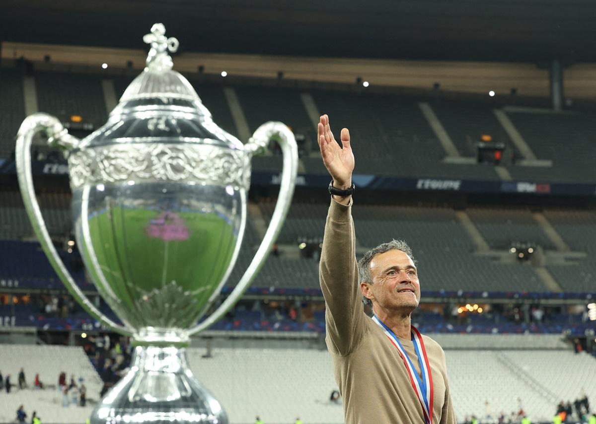 Paris St Germain's coach Luis Enrique waves to the crowd after winning the Coupe de France.