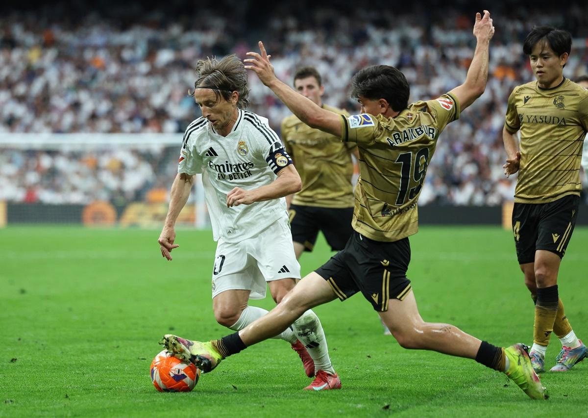 Luka Modric tries to work his way past a host of Real Sociedad defenders.