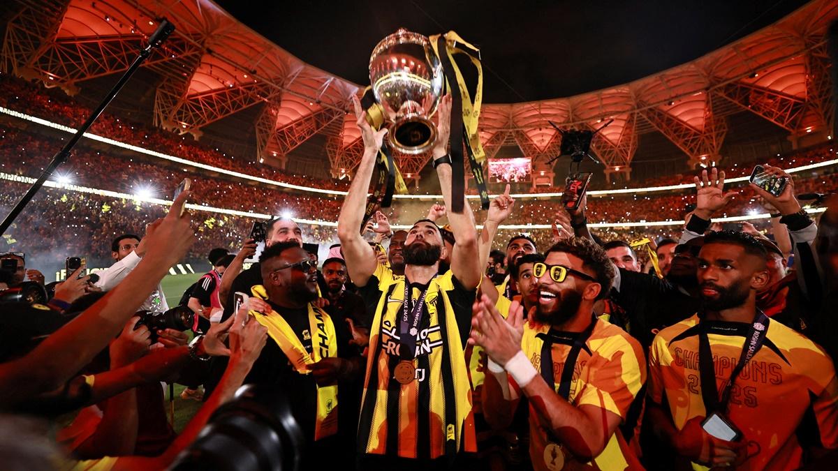 Karim Benzema celebrates with his Al Ittihad teammates as he hoists the trophy after beating the Al Qadsiah in the Saudi King's Cup final, at King Abdullah Sports City, Jeddah, Saudi Arabia, on Friday.