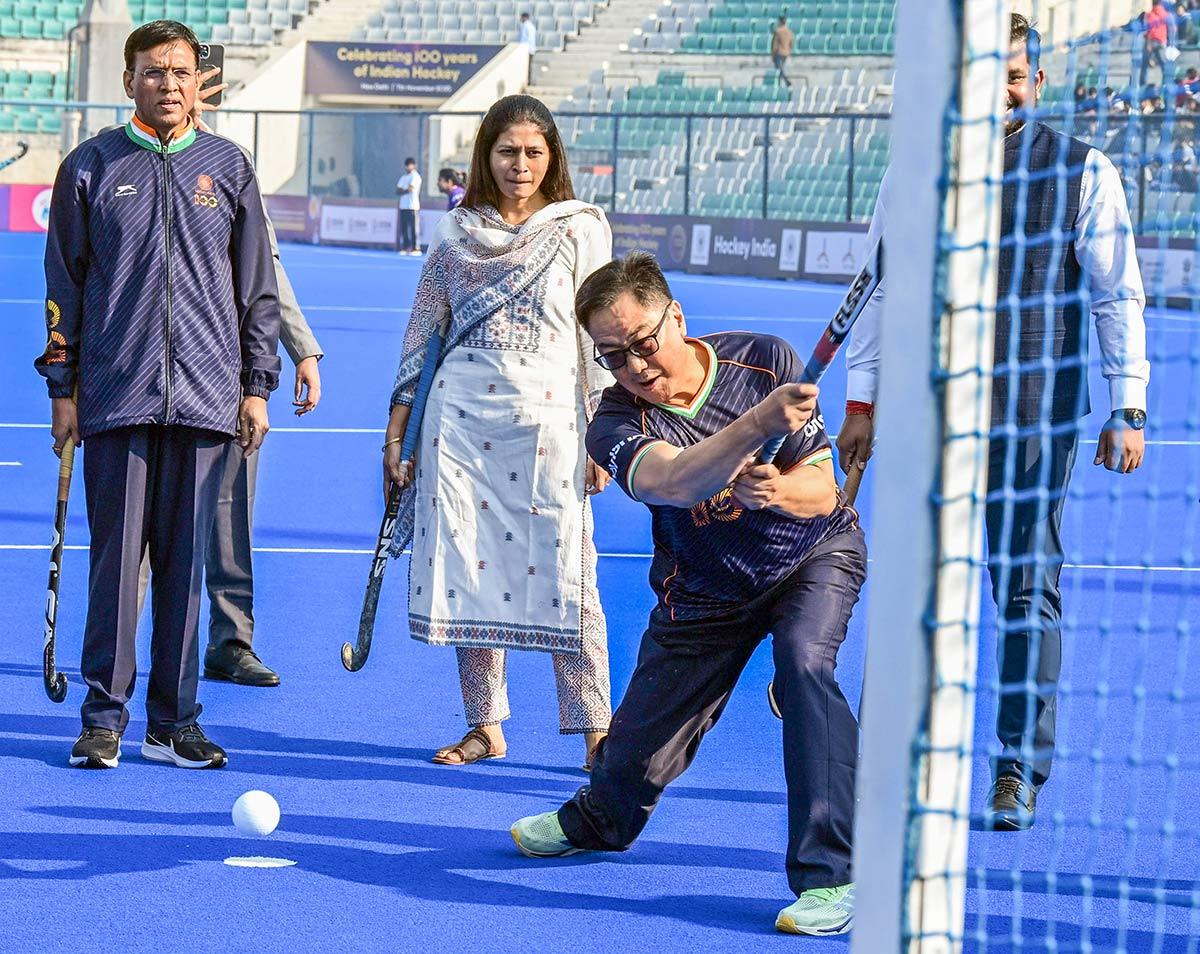 Union Minister Kiren Rijiju plays a shot during an event marking 100 years of Indian hockey at Major Dhyan Chand National Stadium, in New Delhi on Friday. 