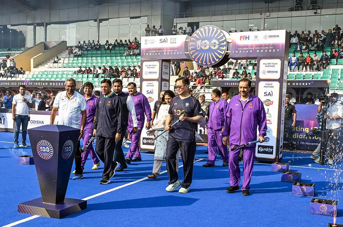 Union Minister Mansukh Mandaviya with Union Minister of Parliamentary Affairs Kiren Rijiju and others during an event marking 100 years of Indian hockey at Major Dhyan Chand National Stadium, in New Delhi on Friday.