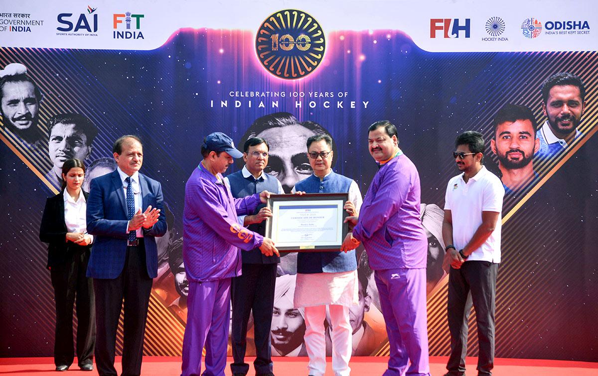 Union Minister Mansukh Mandaviya with Union Minister of Parliamentary Affairs Kiren Rijiju, Tamil Nadu Deputy Chief Minister Udhayanidhi Stalin and others  during an event marking 100 years of Indian hockey at Major Dhyan Chand National Stadium, in New Delhi on Friday.  