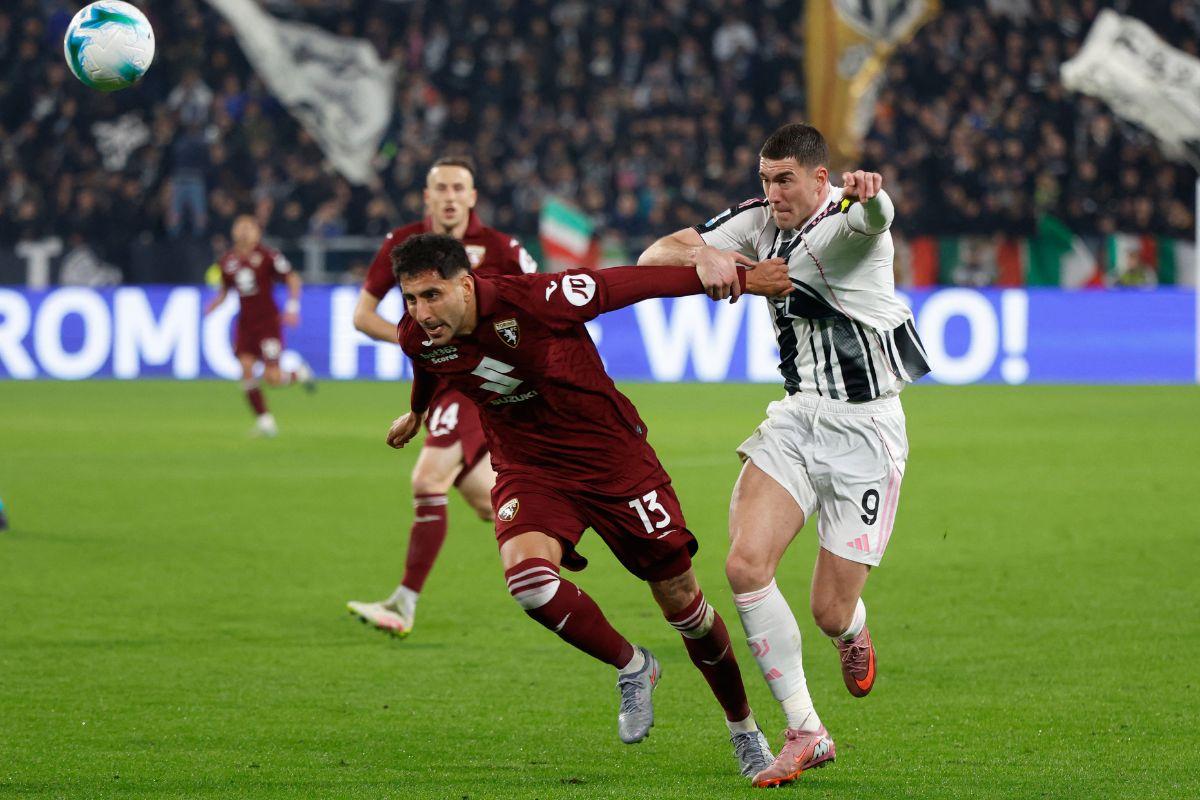 Juventus' Dusan Vlahovic and Torino's Guillermo Maripan vie for possession during their Serie A match at the  Allianz Stadium, Turin, Italy 