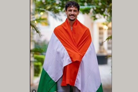 Draped in the Indian tricolour, Ryan Williams was all smiles after receiving his passport on Thursday, November 6