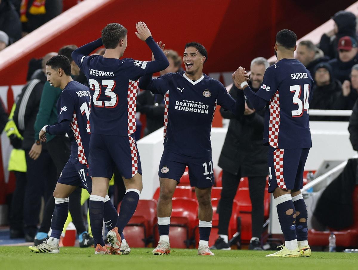 Couhaib Driouech celebrates with teammates after scoring PSV Eindhoven's fourth goal against Liverpool at Anfield, Liverpool.