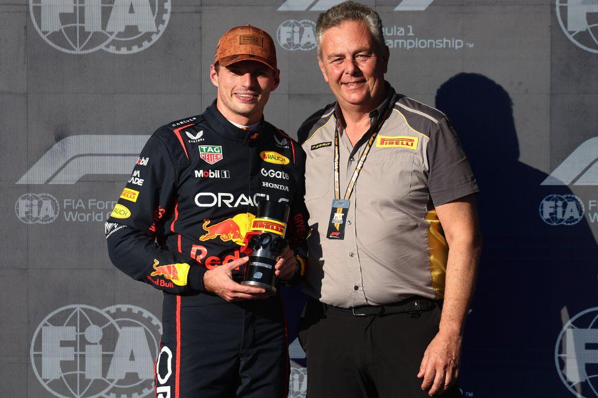 Red Bull's Max Verstappen poses with the sprint award with Pirelli F1 Motorsport Director Mario Isola during the United States F1 Grand Prix at the Circuit of the Americas in Austin, Texas, US, on Friday