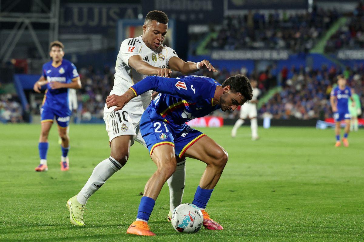 Getafe's Juan Iglesias in action with Real Madrid's Kylian Mbappe during their La Liga match at Estadio Coliseum, Getafe, Spain, on Sunday