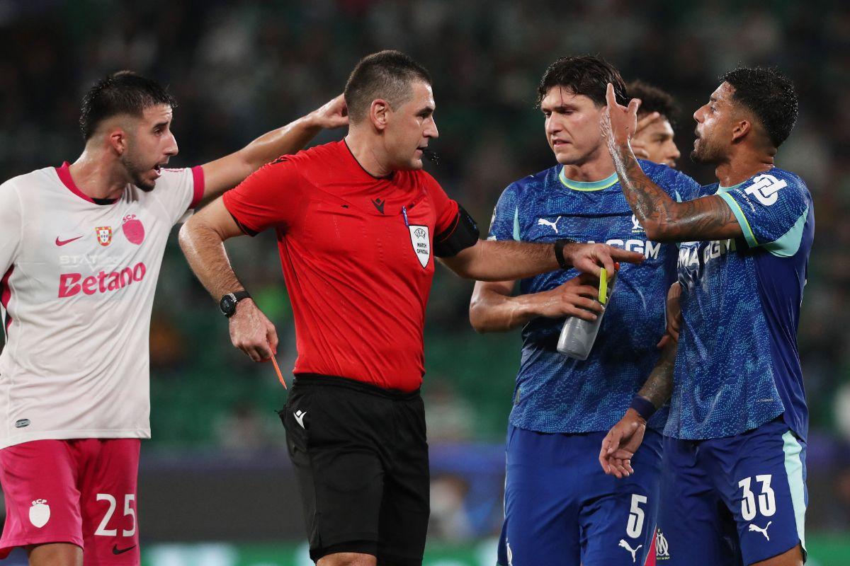 Olympique de Marseille's Emerson Palmieri reacts after being shown a red card by referee Rade Obrenovic after receiving two yellow cards