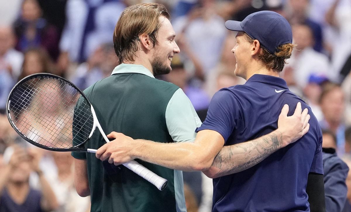 Jannik Sinner and Alexander Bublik walk off the court after the match.
